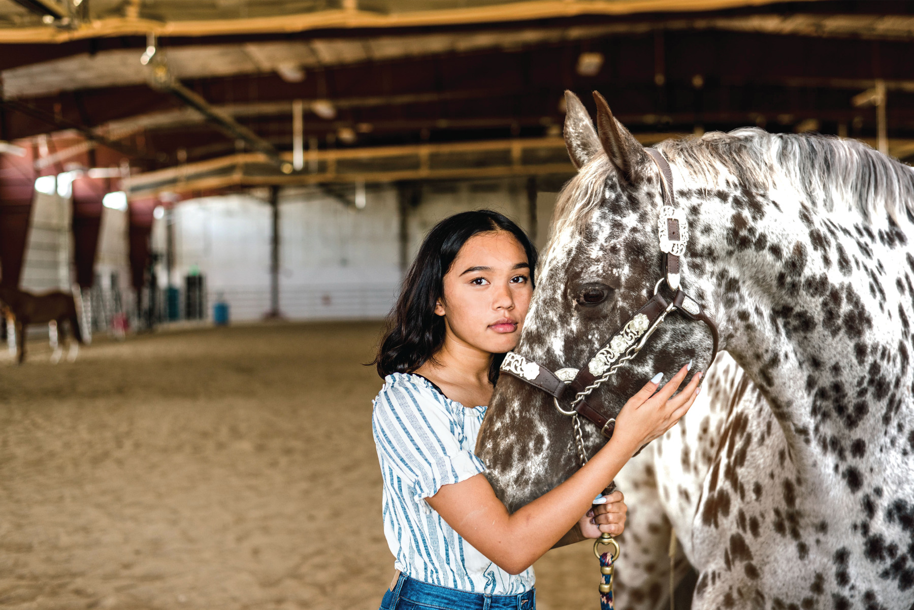 A girl and an Appaloosa horse