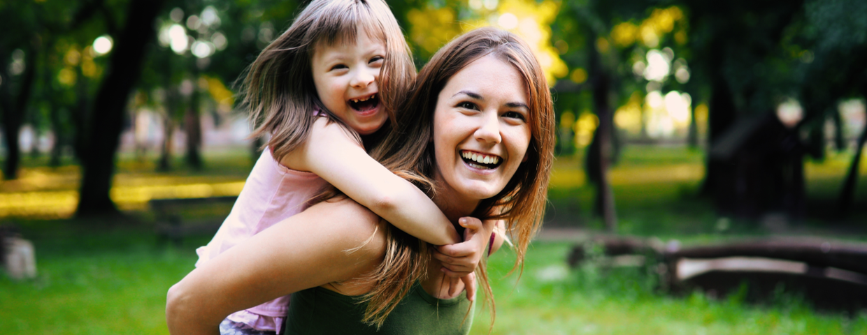 little girl with special needs huggig woman