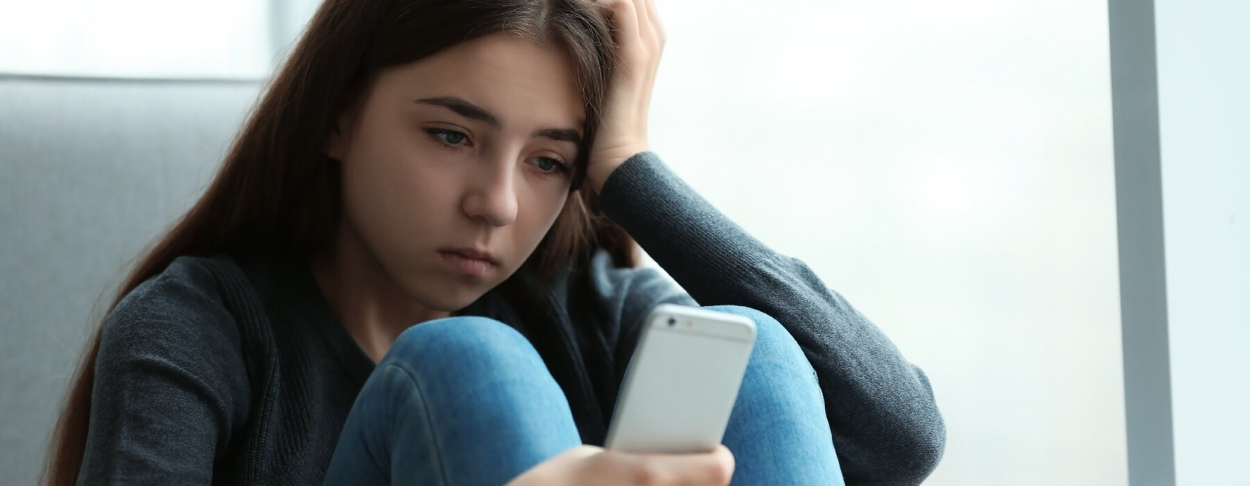 sad teen girl with cellphone