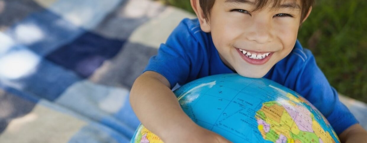 Close-up portrait of a cute young boy holding globe at the park-433929-edited