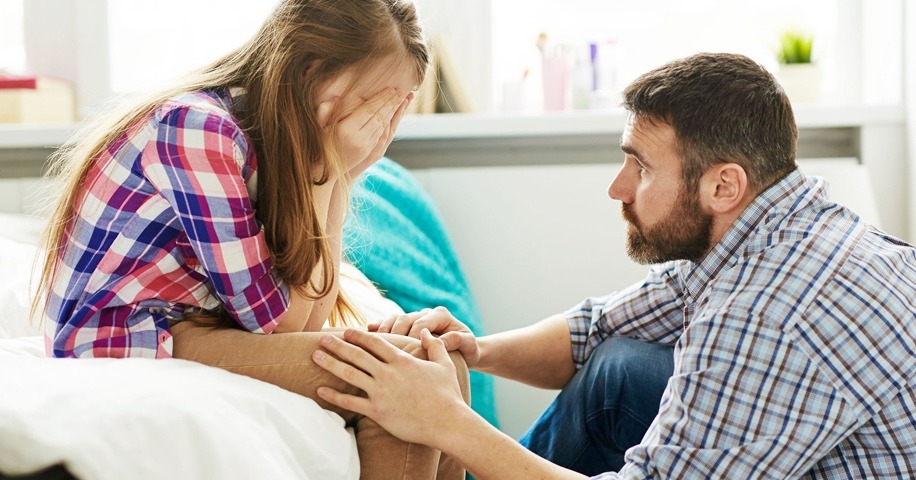 Father talking to daughter on bed-1