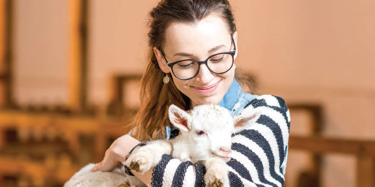 Young person holding a therapy animal