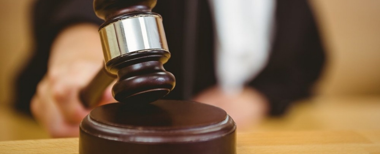 Hand about to bang gavel on sounding block in the court room-318935-edited-1
