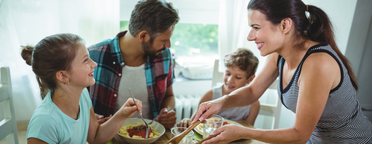 a mother serving dinner to family