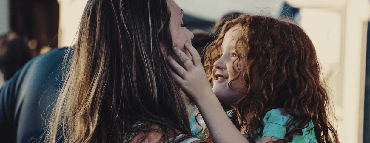 Mother holding young daughter