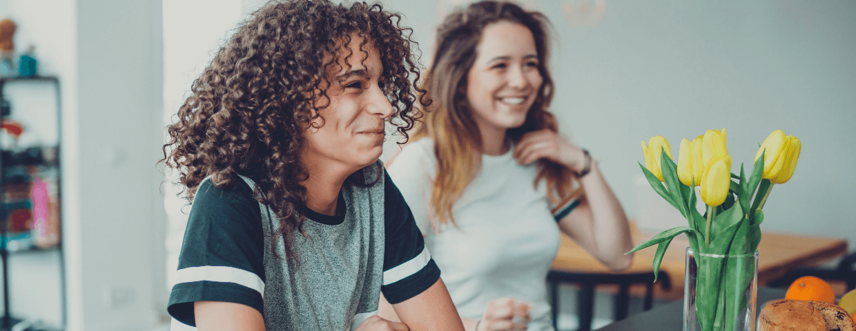 two teens in kitchen laughing