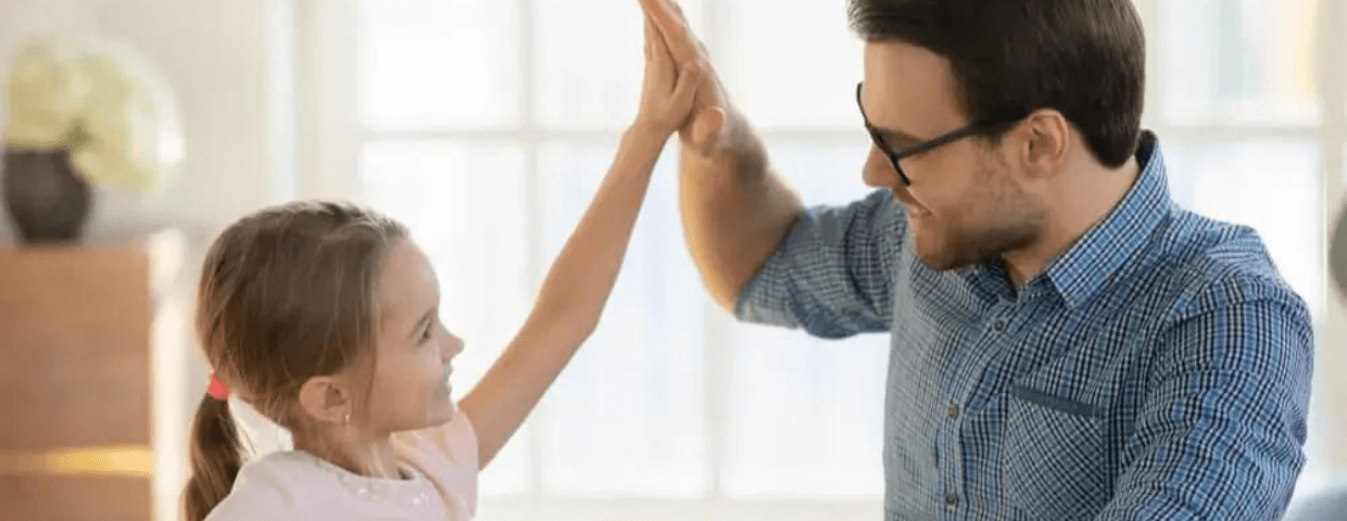 father and daughter high-fiving