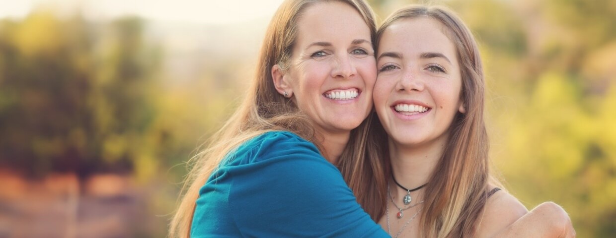 Woman hugging daughter