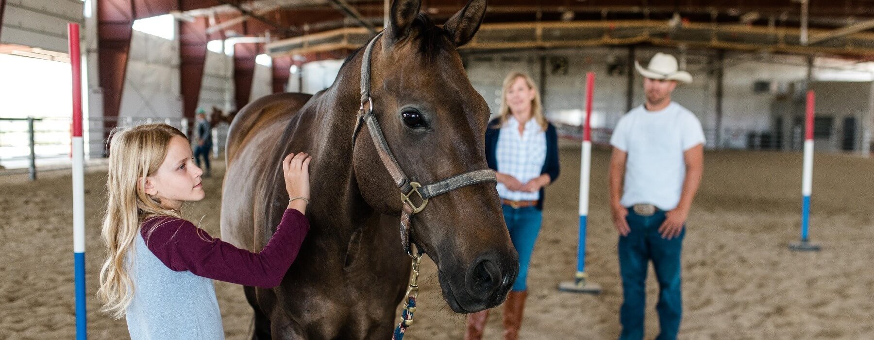 young teen girl in equine therapy session with horse